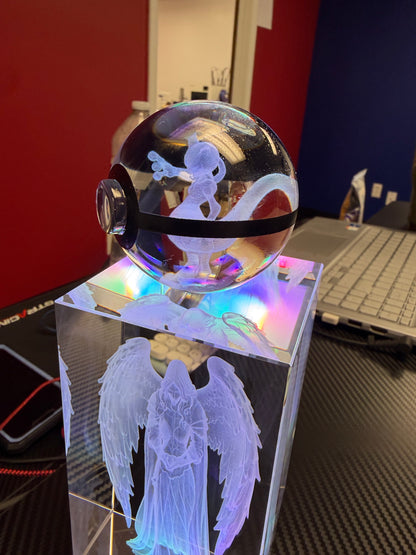 Illuminated crystal sphere and rectangular angel keepsake displayed on LED bases