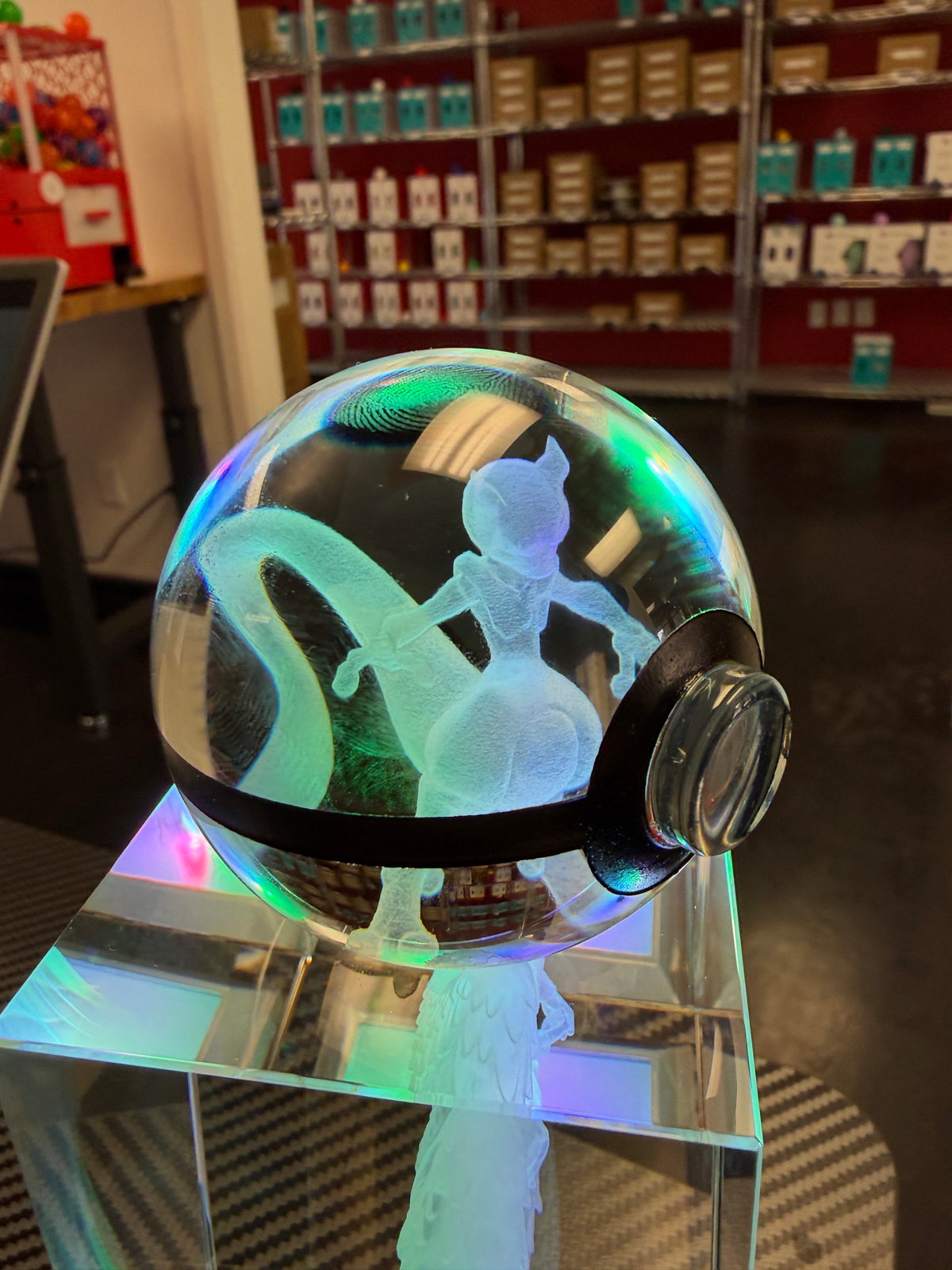 Close-up of a personalized crystal sphere glowing on an LED base