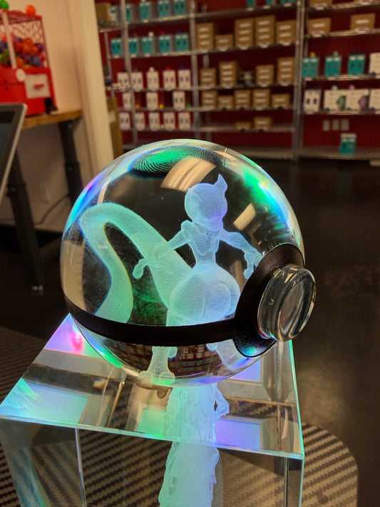 Close-up of a personalized crystal sphere glowing on an LED base