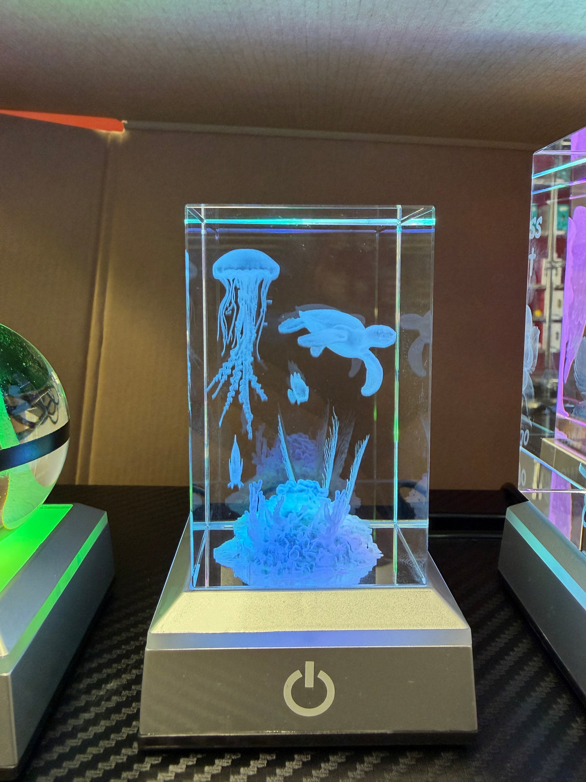 Aquarium scene engraved inside a glowing rectangular crystal keepsake