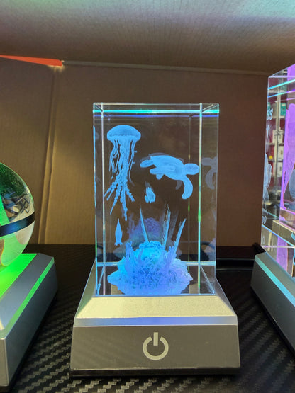 Aquarium scene engraved inside a glowing rectangular crystal keepsake
