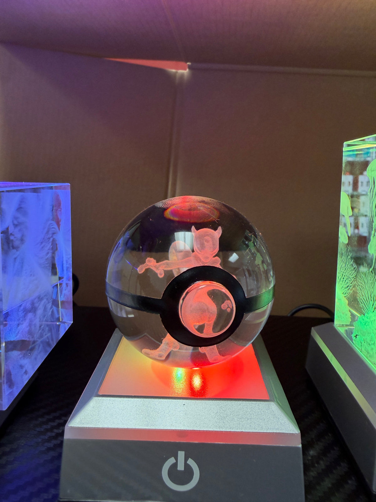 Crystal sphere illuminated in red on a color-changing LED display base