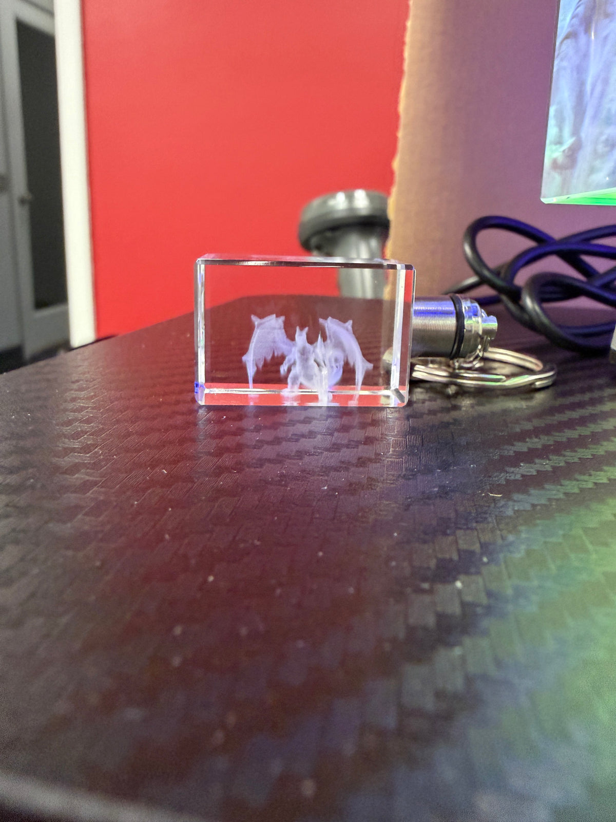 Light-up crystal keychain with an engraved fantasy creature design