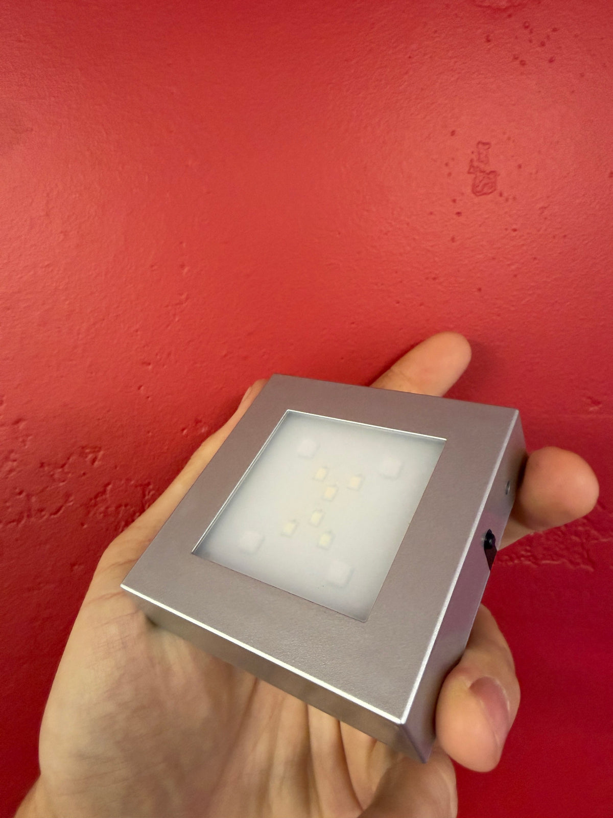 Large silver LED display base angled to show the illuminated top and power control