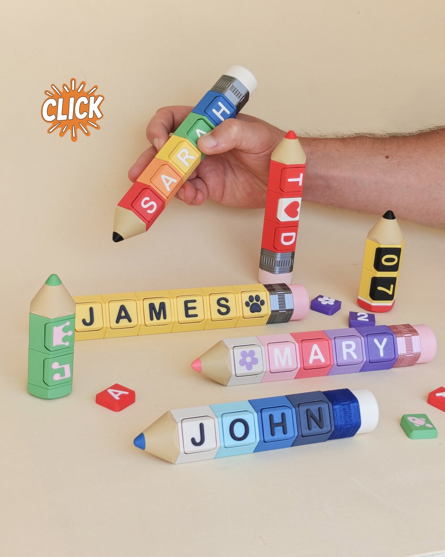 Personalized 3D printed pencil clicker keychains with colorful letter and symbol blocks